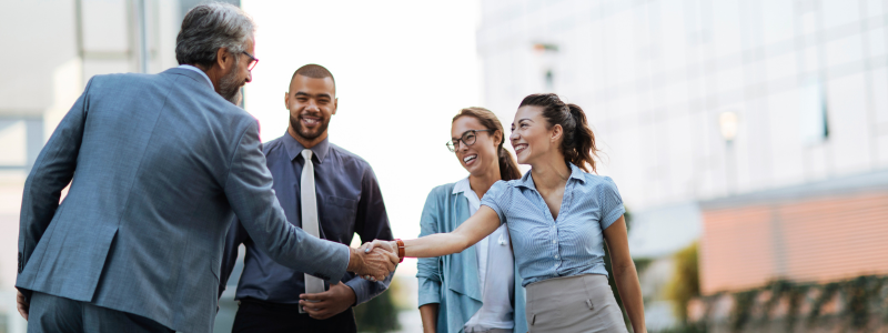 Female business woman shaking hands with male business man