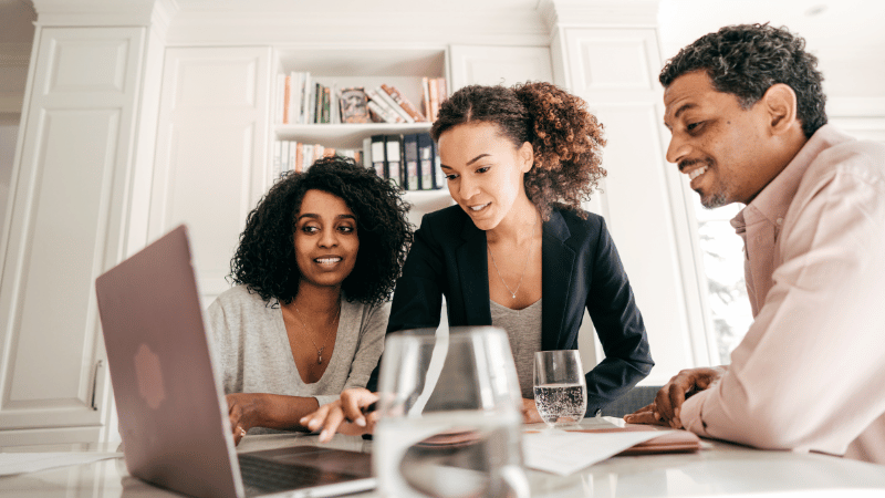 Two females and one male looking at a laptop - Real estate marketing tool - Tips for Brokerage Branding in the Digital Age