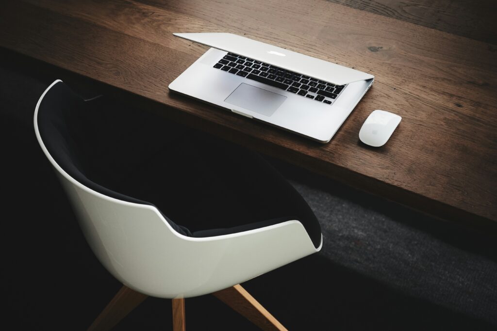 Desk with laptop, chair and mouse - Real estate marketing