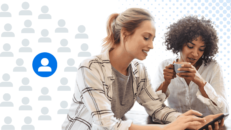 Two women sitting having coffee together looking at their phone - soi in real estate