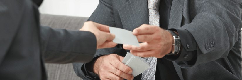 real estate agent handing over a business card