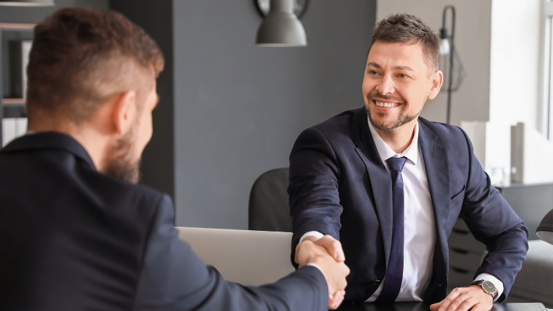 Homeowner shaking hands with real estate agent